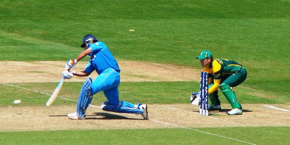 MS Dhoni batting against South Africa during the 2013 ICC Champions Trophy group stage, 6 June 2013. AB de Villiers keeping wicket.