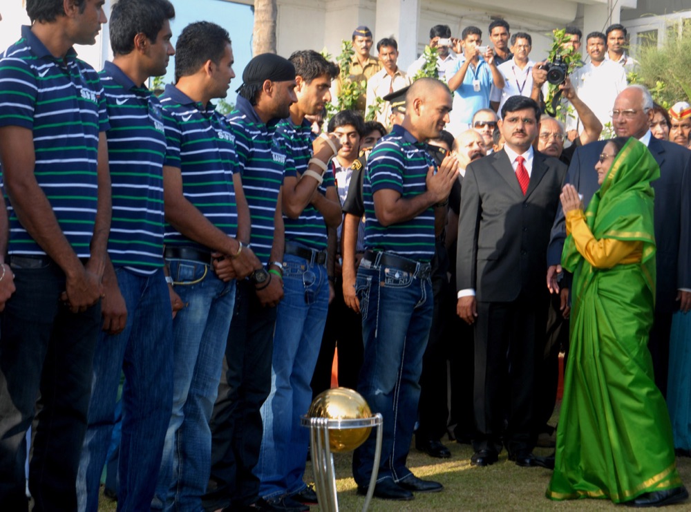 India's 2011 World Cup-winning cricketers, including MS Dhoni, meet President Pratibha Patil beside the trophy the day after the final