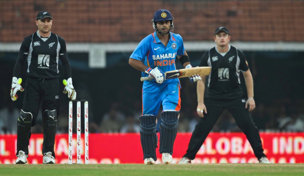 Virat Kohli batting for India against New Zealand, 10 December 2010; source category identifies the match. Visible India blue kit, bat, stumps and New Zealand fielders.